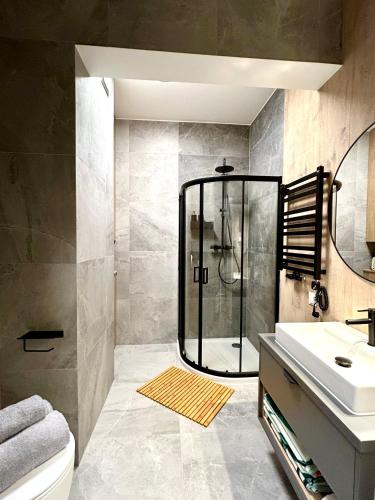a bathroom with a shower and a sink at Augustów apartament nad jeziorem in Augustów