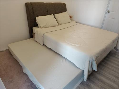 two beds in a small room with at Skyedwight Condo - 1 Bedroom Pool View with Gym and Free WiFi Near Airport in Pusok