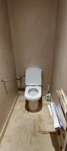 a bathroom with a white toilet in a room at Taghazout Hillside Apartment with Swimming Pool in Taghazout