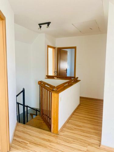 an empty room with a mirror and a staircase at Komplettes Monteur Haus in Hannover