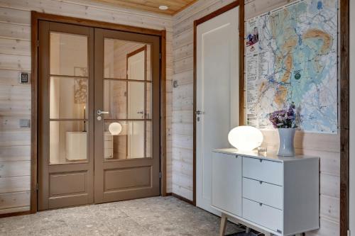 a room with a door and a map on the wall at Lapland Fellas - Äkäslompolo in Äkäslompolo