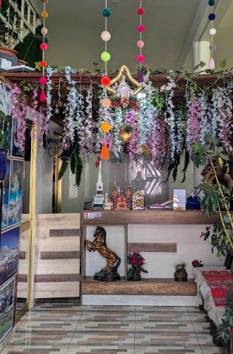 a store with flowers hanging from the ceiling at Sumaq Wari Hotel in Ayacucho