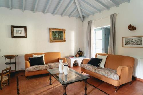 a living room with two couches and a table at CABRA - Porto Covo in Porto Covo