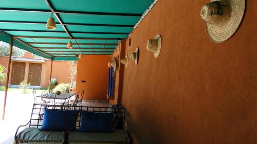 a patio with awning and a table and chairs at Villa des Roses Privée in Marrakech