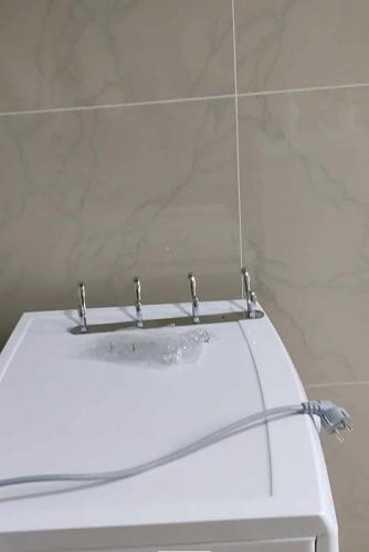 a white sink in a bathroom with a mirror at Korca Apartament Koci in Korçë