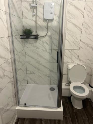 a bathroom with a shower with a toilet at Stylish 1 Bedroom Apartment Near Sheffield in Kimberworth