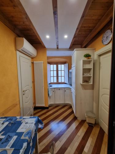 a room with yellow walls and wooden floors and a window at Pontedecimo Apartment Two in Genova