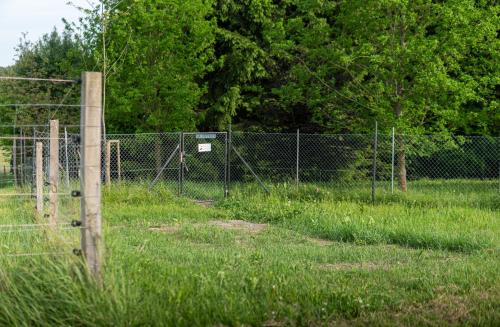 a fence in the middle of a field at Na mýtince in Hořice na Šumavě