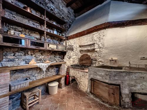 a kitchen with a stove and a stone wall at The Historic Oil Mill- Romantic Retreat in Alassio
