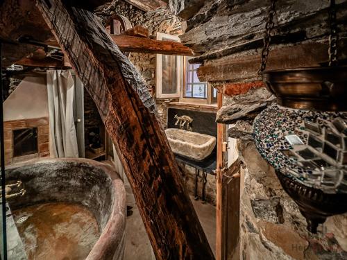 a bathroom with a sink and a stone wall at The Historic Oil Mill- Romantic Retreat in Alassio