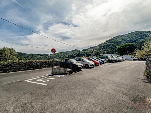 a parking lot with cars parked next to a stop sign at The Historic Oil Mill- Romantic Retreat in Alassio