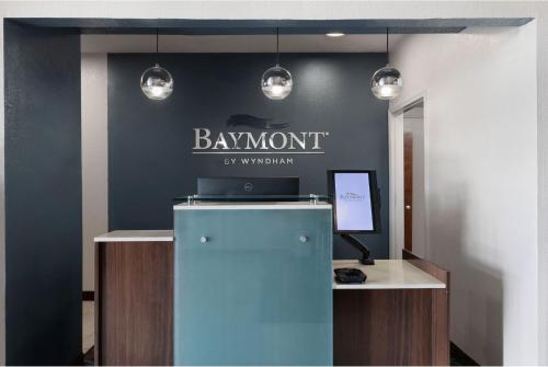 a sign on a wall that reads baymont by marriott at Baymont by Wyndham Moss Point in Moss Point
