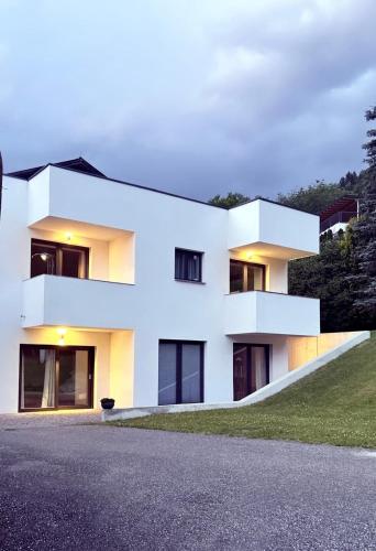 a white house with black windows at Apartment Oberleins I in Arzl im Pitztal
