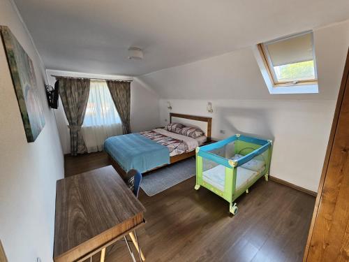 a small bedroom with a bed and a table at Casa In Curte La Zavate in Bran