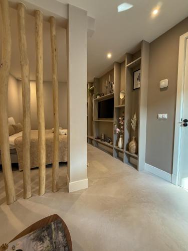 a bedroom with a bed with wooden posts at B&B De Amsterdamse Poort in Haarlem