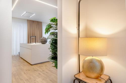 a living room with a lamp on a table at Petraianca Panoramic BH in Marina di Ragusa