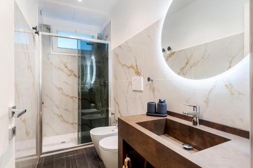 a bathroom with a sink and a toilet at Petraianca Panoramic BH in Marina di Ragusa
