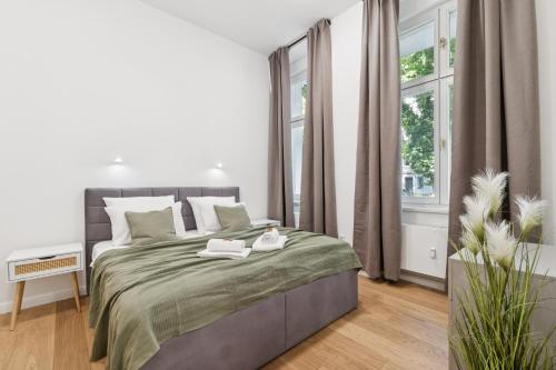 a white bedroom with a large bed and a window at Modern Apartment in Berlin in Berlin