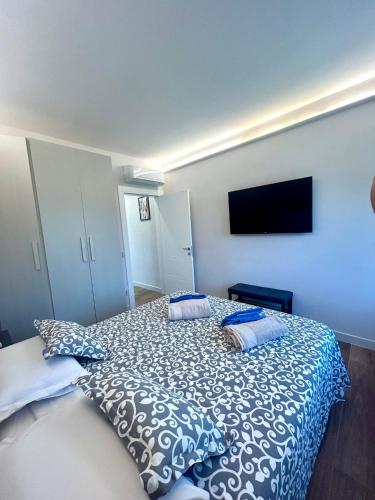 a bedroom with a bed and a tv on the wall at Rustico del Chiasso in Capannori