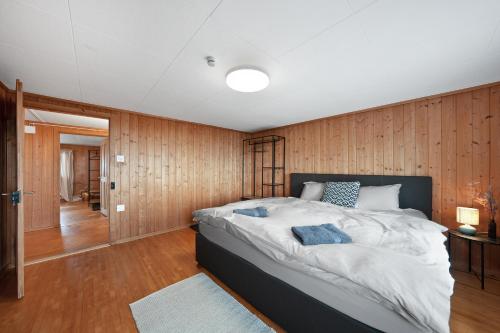 a bedroom with a large bed and wooden walls at Gasthaus Oberer Gäbris in Gais