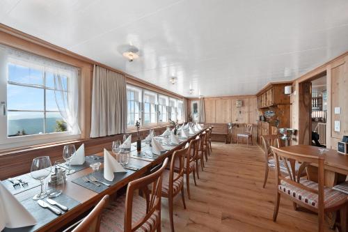 a large dining room with a long table and chairs at Gasthaus Oberer Gäbris in Gais