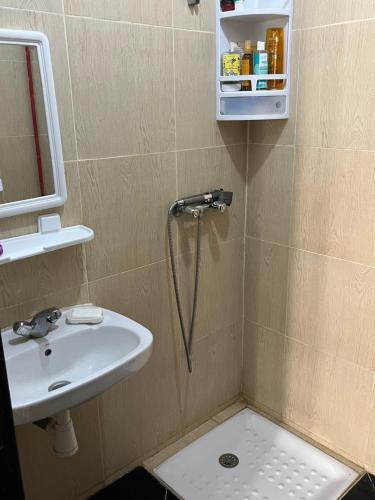 a bathroom with a sink and a shower at Tarik alkhir in Agadir