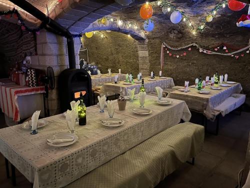 a set of tables in a room with lights at Private Guest House with Wine Cellar in Felsőtárkány