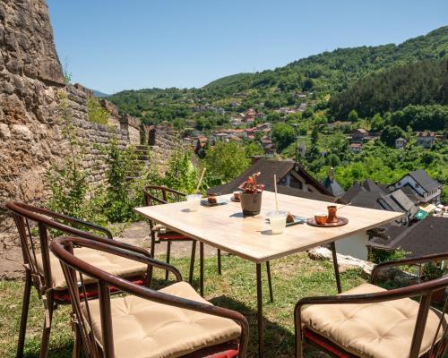 a table with chairs sitting on top of a mountain at The Crown Panorama in Jajce