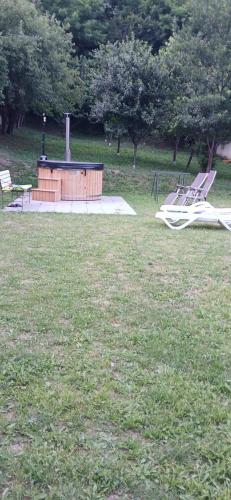 a park with a playground with a slide in the grass at PENSIUNEA ANA Transalpina in Şugag