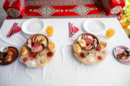 a white table with two plates of food on it at The Crown Panorama in Jajce