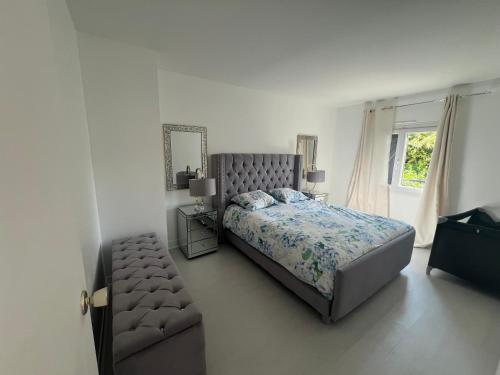 a bedroom with a bed and a chair and a window at Maison Serenity Domont Retreat in Domont