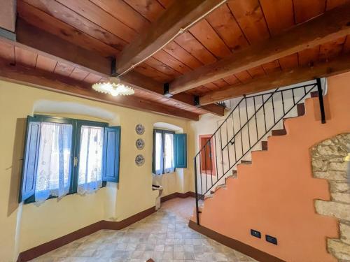 a hallway with a staircase in a house at Sardinian Gallery Bonaria in Bosa