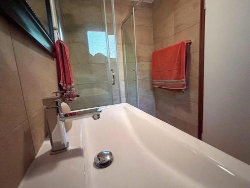 a bathroom with a bath tub with a shower at The Nature Nook in Vosburg