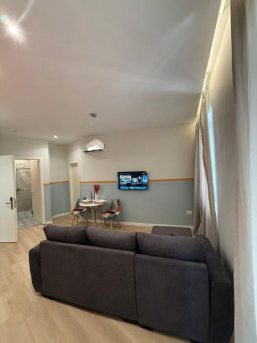 a living room with a couch and a table at Modern City Centre Apartment in Durrës