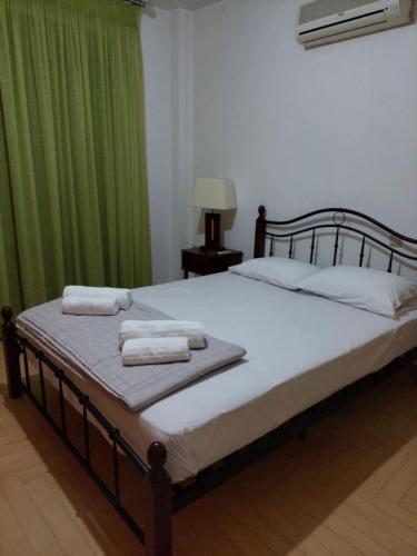 a bedroom with a bed with two towels on it at Aylida House in Paralía Avlídhos