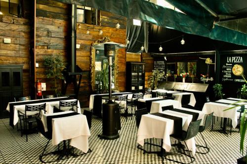 a dining room with white tables and chairs at Grand Bellas artes in Santiago