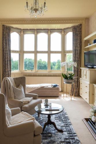 a living room with a couch and a table at Horsted Place Hotel in Uckfield