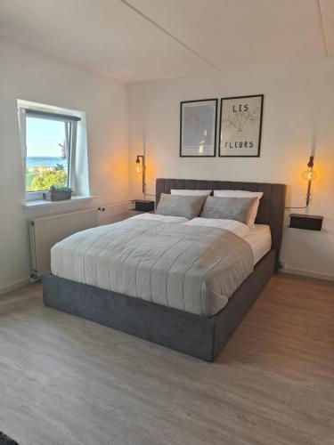 a bedroom with a large bed and a window at Modern Apartment With Pool & Fitness in Hejls
