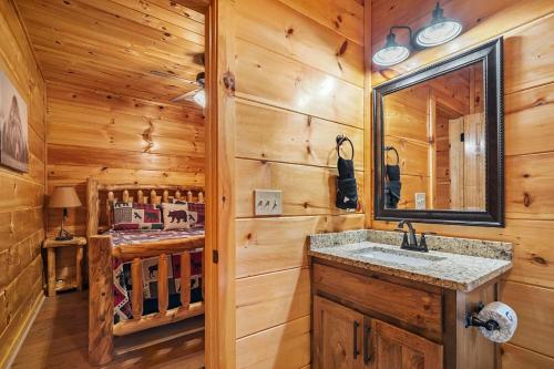 a bathroom with a sink and a mirror at Hickory Haven By Avada Properties in Gatlinburg