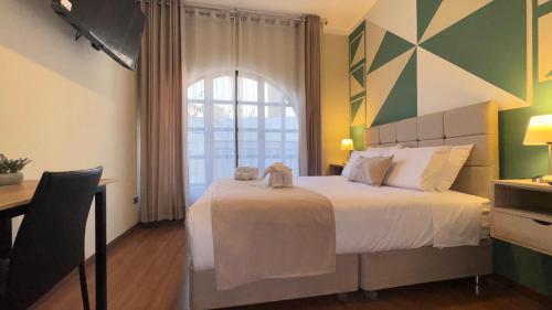 a bedroom with a large bed and a window at Andari Hoteles in Arequipa
