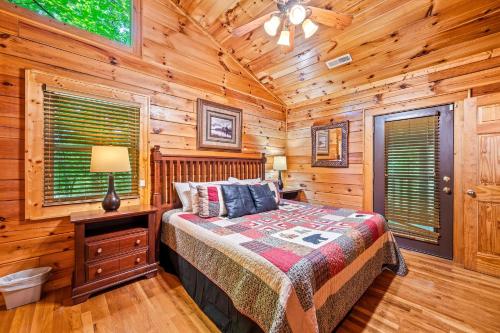 Forest Creek Retreat By Avada Properties في سيفيرفيل: غرفة نوم مع سرير في كوخ خشبي