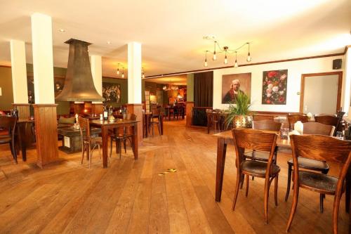 a dining room with wooden tables and chairs at Holiday Home Maridu Wellness in Arnhem
