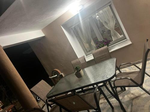 a table and chairs in a room with a window at MARIALENA HOMe in Petropiyí