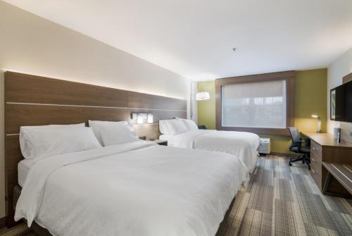 a hotel room with two beds and a television at Holiday Inn Express - Plymouth by IHG in Plymouth