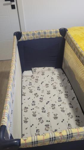 a bed with a sheet with animals on it at Apartman Lakers in Ostrovo
