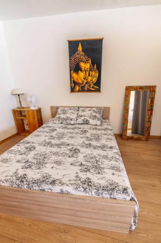 a bedroom with a bed with a black and white comforter at Appartement dans le centre médiéval in Hyères