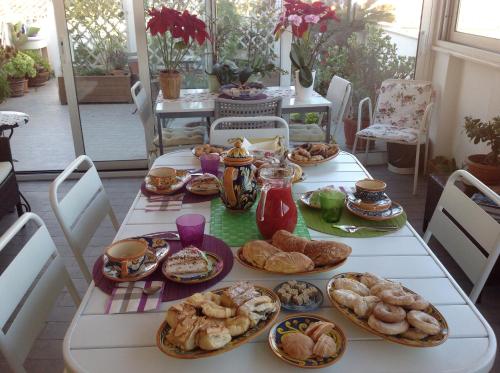 a table with a bunch of food on it at Attico Da Rosa con vista spettacolare a 360 gradi in Caltagirone