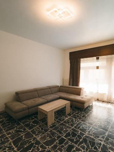 a living room with a couch and a coffee table at Appartamenti Rivo Gelassa in Susa