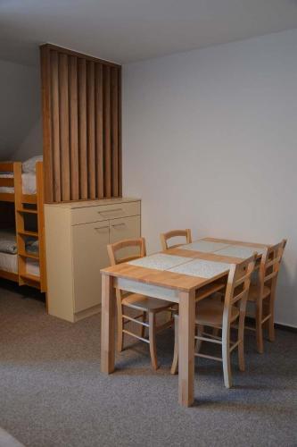 a table and chairs in a room with a bedroom at Župky in Županovice