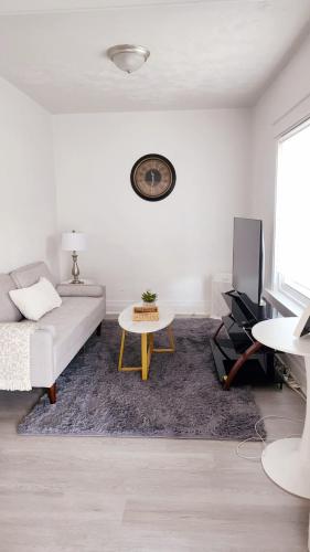 a white living room with a couch and a table at New Renovated USA Side in Niagara Falls